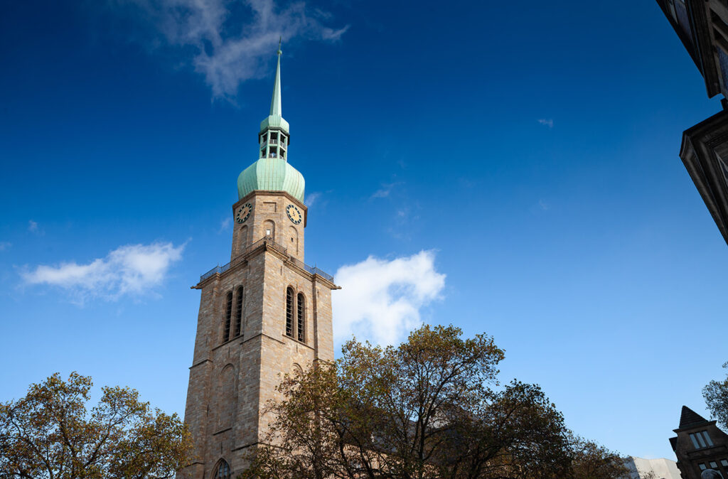 Picture of the chuch of reinoldikirche church in Dortmund, Germany. The Lutheran Protestant Church of St. Reinold is, according to its foundation date, the oldest extant church in Dortmund, Germany; it is dedicated to Reinold, also known as Renaud de Montauban, the patron of the city. The church was built as a palatine church in the Ottonian era. The present building is a late Romanesque church with a late gothic quire. St. Reinold's was built from 1250 to 1270, and is located in the centre of the city, directly at the crossing of the Hellweg (a historic trade route) and the historic road from Cologne to Bremen. St. Reinoldi's congregation is a member of the Evangelical Church of Westphalia, an umbrella comprising Lutheran, Reformed and united Protestant congregations.