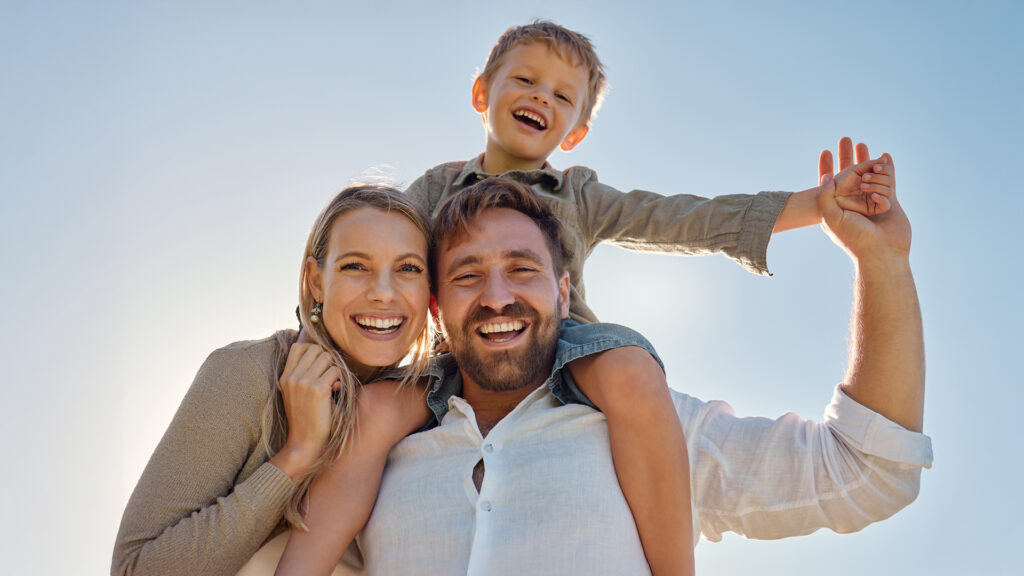 Family, mother and father with child, for holiday, vacation and being happy together outdoor. Portrait, mama and dad with kid for quality time, travel and bonding being loving, carry boy and have fun