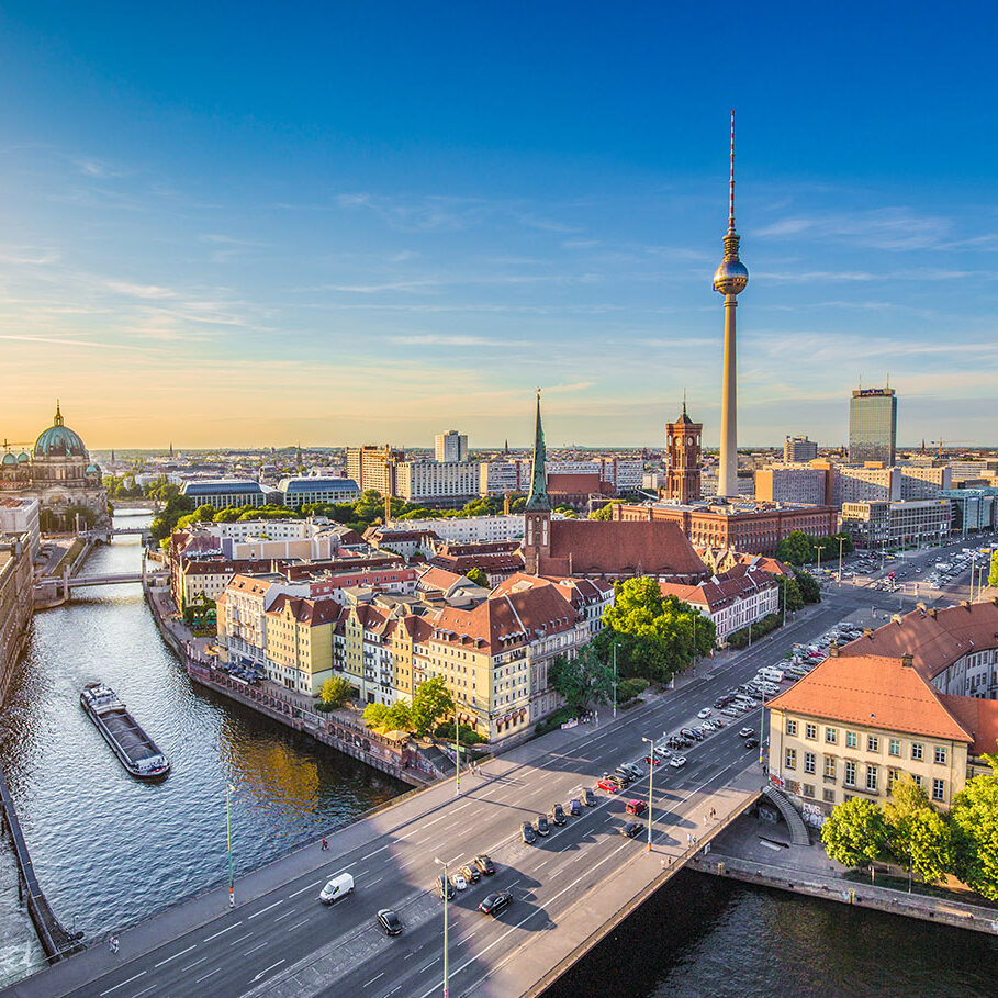 Aerial view of Berlin skyline with famous TV tower and Spree river in beautiful evening light at sunset, Germany.