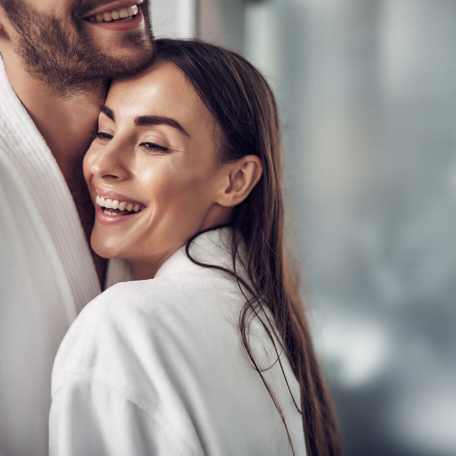 Lovely pair in white bathrobe hugging each other