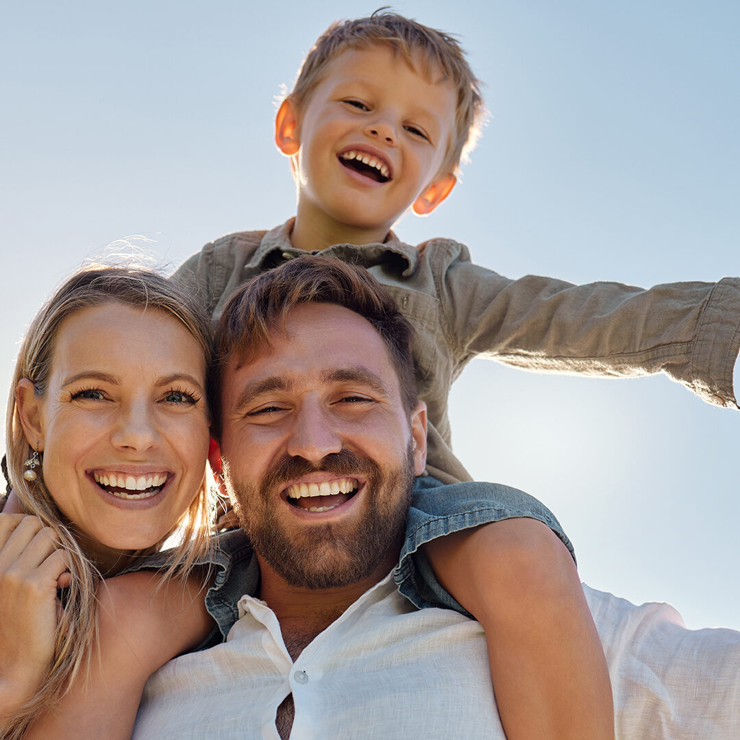 Family, mother and father with child, for holiday, vacation and being happy together outdoor. Portrait, mama and dad with kid for quality time, travel and bonding being loving, carry boy and have fun