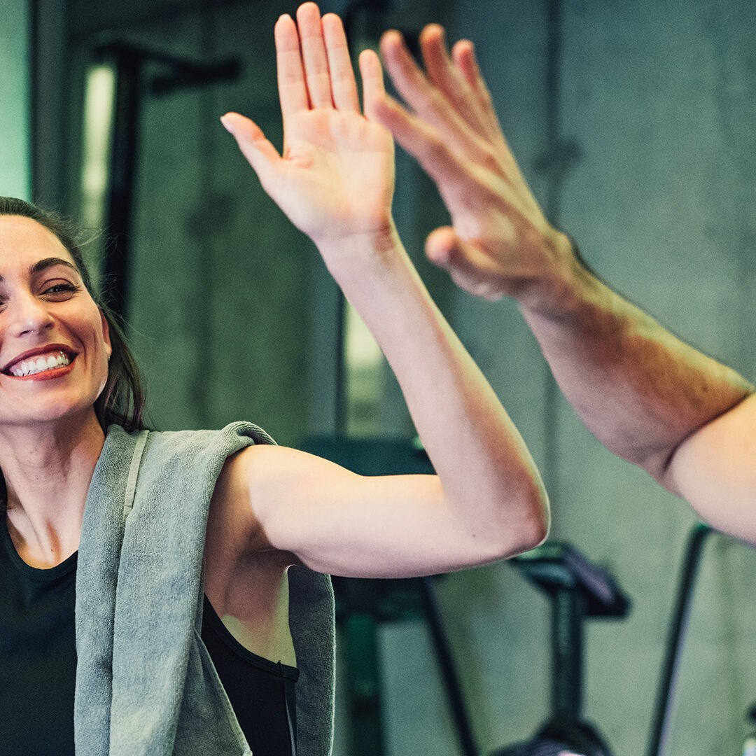 Shot of an young couple exercising together in the gym.