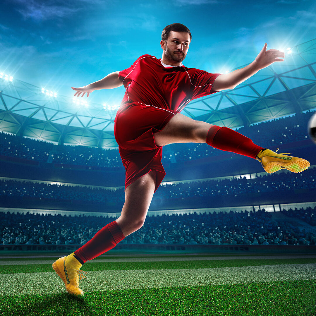 Soccer player in action on night stadium background