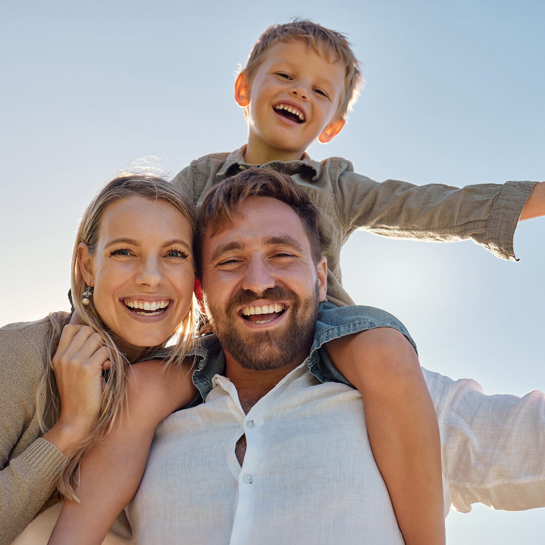 Family, mother and father with child, for holiday, vacation and being happy together outdoor. Portrait, mama and dad with kid for quality time, travel and bonding being loving, carry boy and have fun